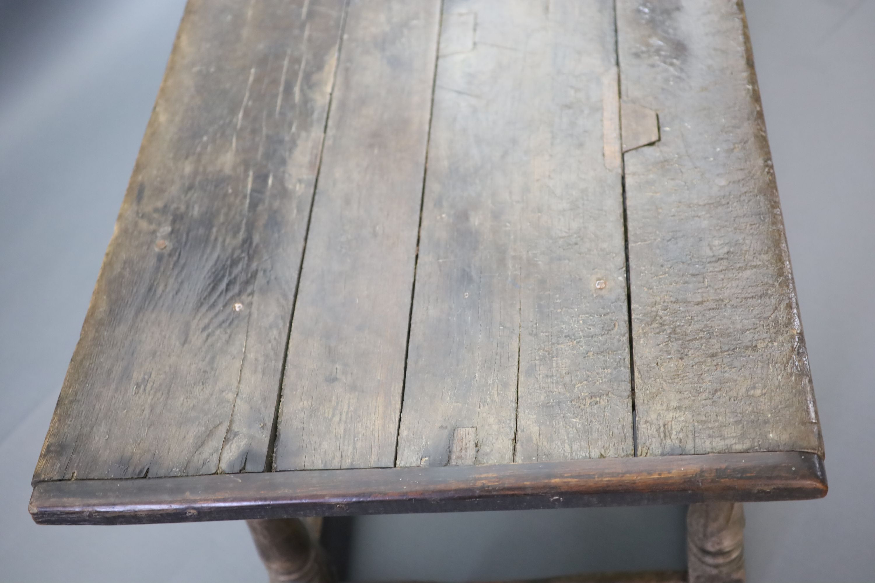 A 17th century oak and elm refectory table, L.255cm W.82cm H.78cm